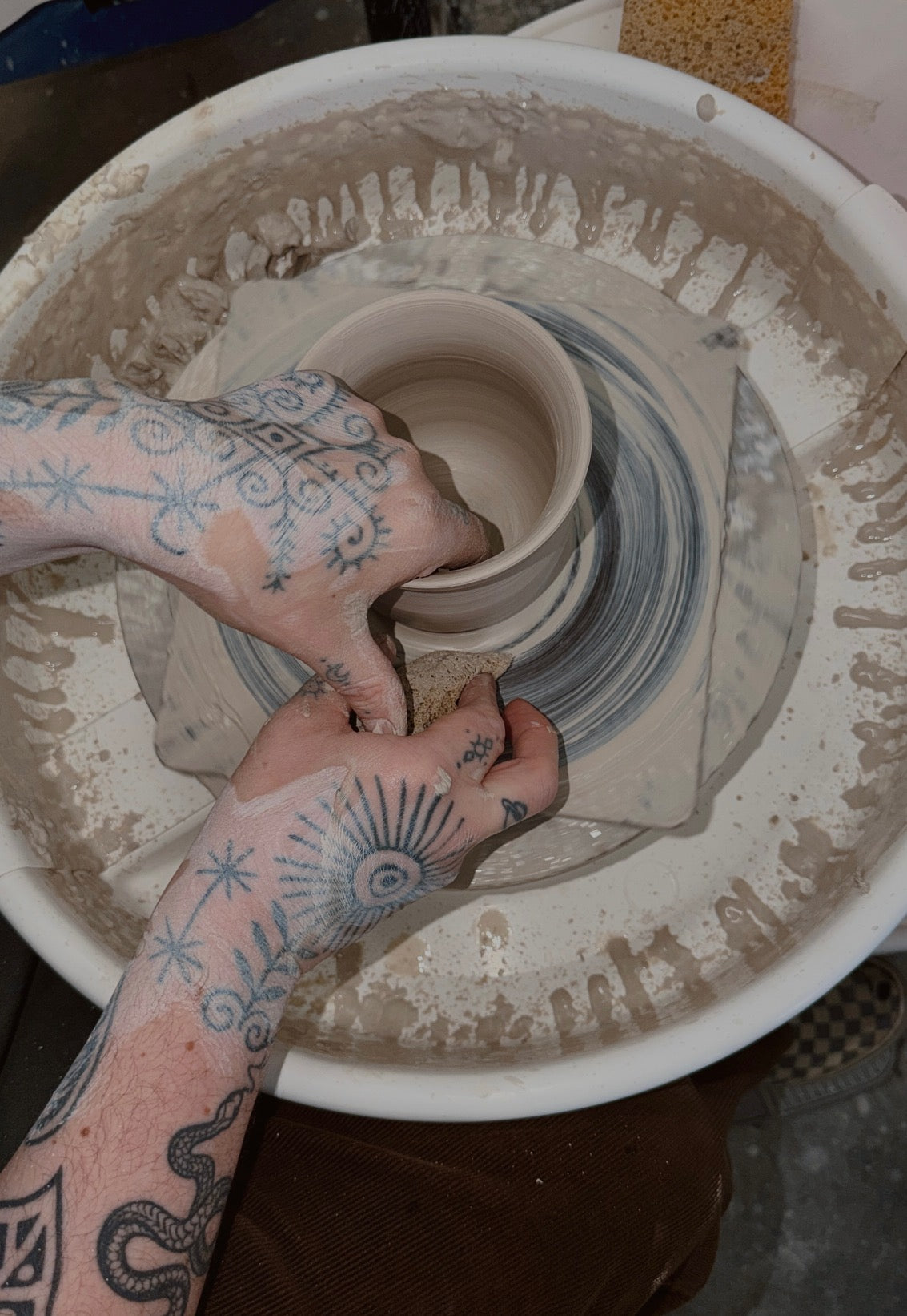 Picture of Ramona prepping the clay on her wheel.